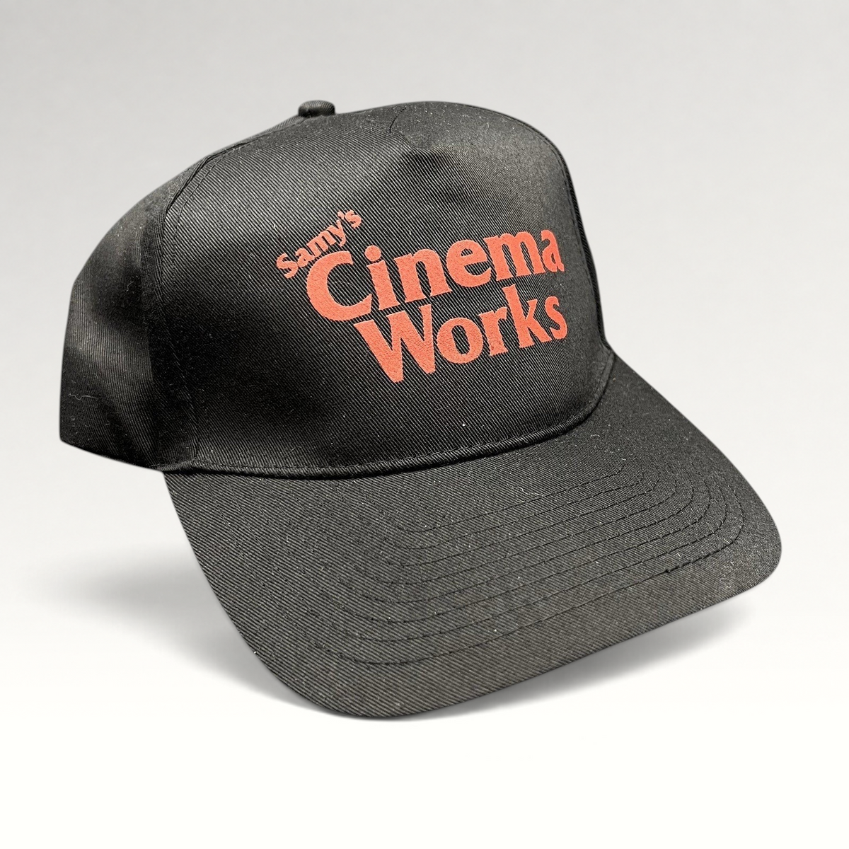 Raree Finds black cotton twill strapback hat with red Samy’s CinemaWorks embroidery on the front crown.