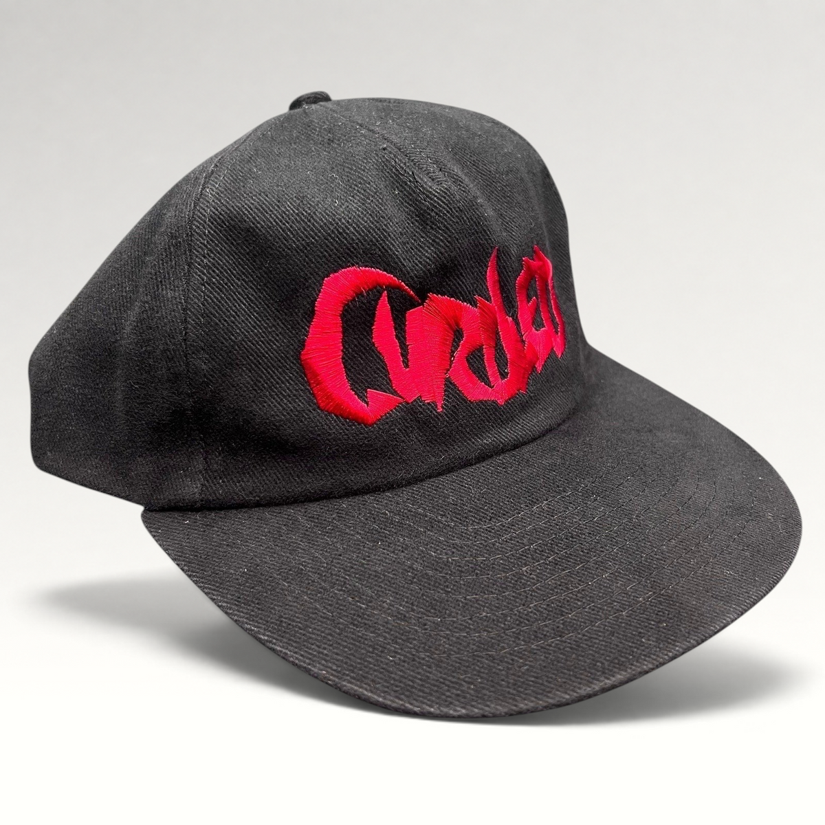 Raree Finds black snapback hat with red embroidered Curdled metal band logo on the front panel