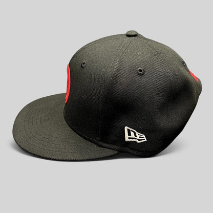 Raree Finds black New Era 9FIFTY snapback hat with red embroidered logo and white side branding on a flat bill.