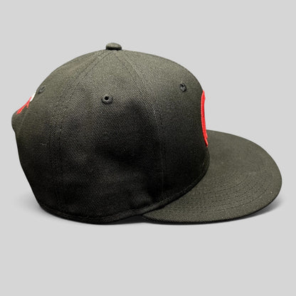 Raree Finds black New Era 9FIFTY snapback hat with red embroidered logo and flat bill, side profile view