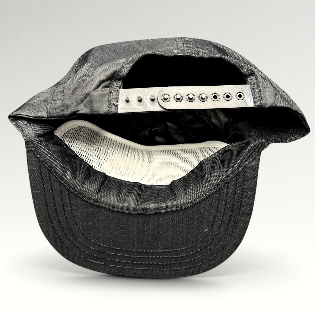 Raree Finds vintage black ripstop nylon snapback hat with adjustable closure and white interior mesh lining