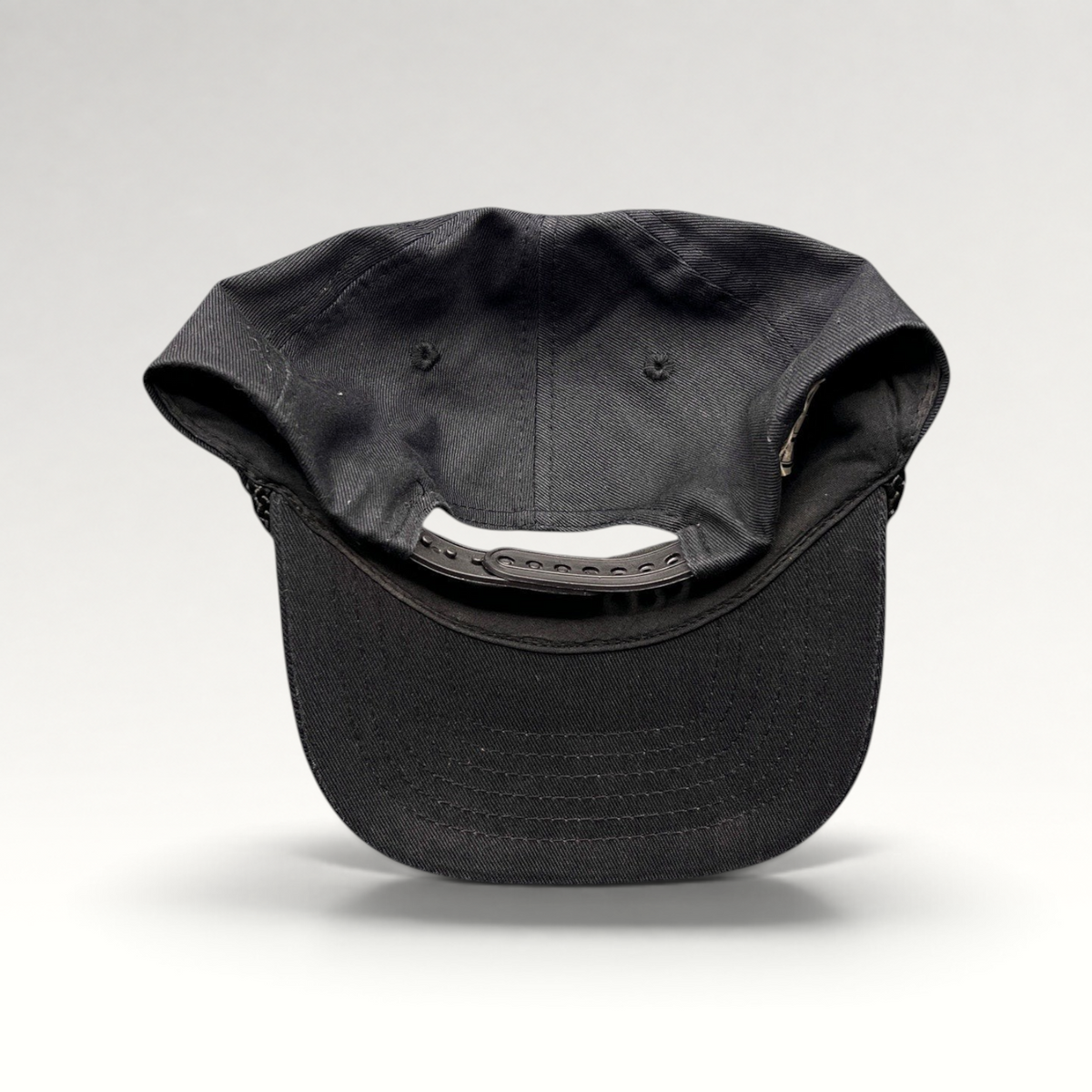 Raree Finds vintage black cotton snapback hat with rope trim and adjustable back closure, rear view.