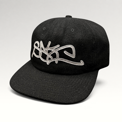 Raree Finds black Sake Brand strapback hat with oversized gray embroidered script logo and flat brim streetwear design.
