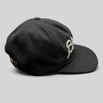 Raree Finds black Sake Brand strapback hat with gray embroidered script logo and leather strap closure