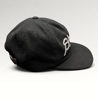 Raree Finds black Sake Brand strapback hat with gray embroidered script logo and leather strap closure