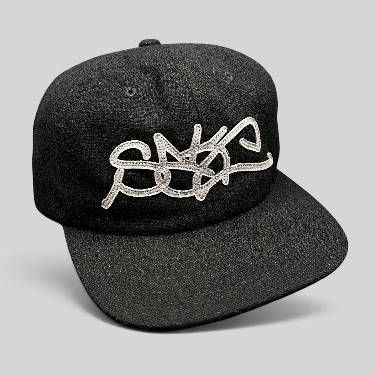 Raree Finds black Sake Brand strapback hat with oversized gray embroidered script logo and flat brim design