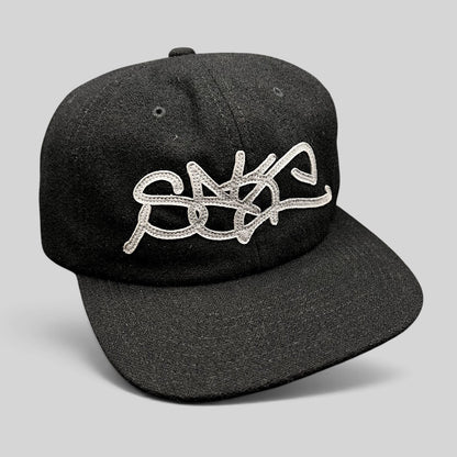 Raree Finds black Sake Brand strapback hat with oversized gray embroidered script logo and flat brim design