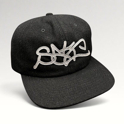 Raree Finds black Sake Brand strapback hat with oversized gray embroidered script logo and flat brim design