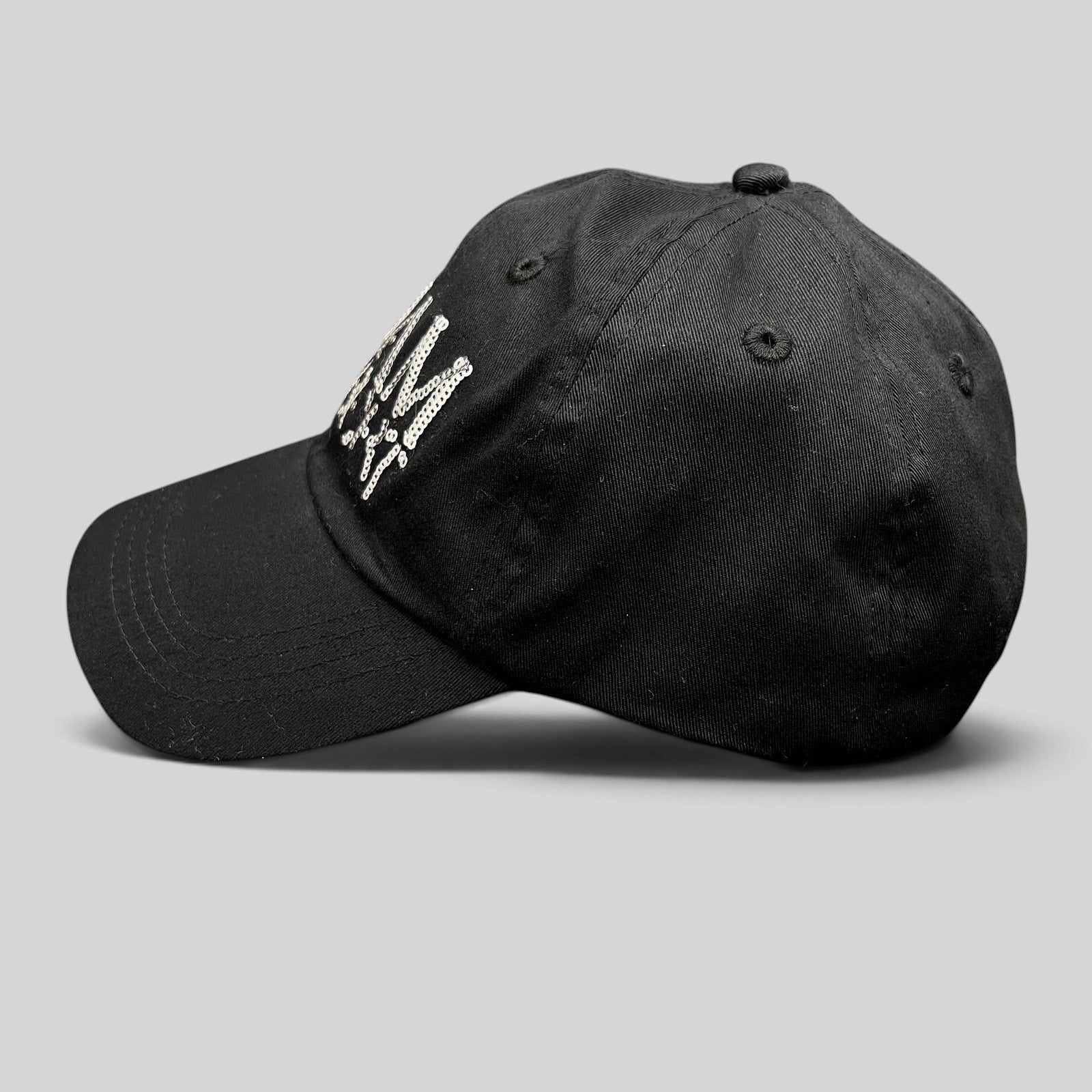 Raree Finds black cotton snapback hat with silver sequin Adam Lambert logo, side profile view.