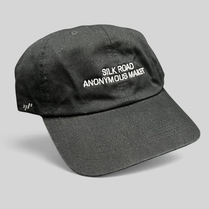 Raree Finds black Yupoong dad cap with white Silk Road Anonymous Market embroidery and adjustable strapback closure.
