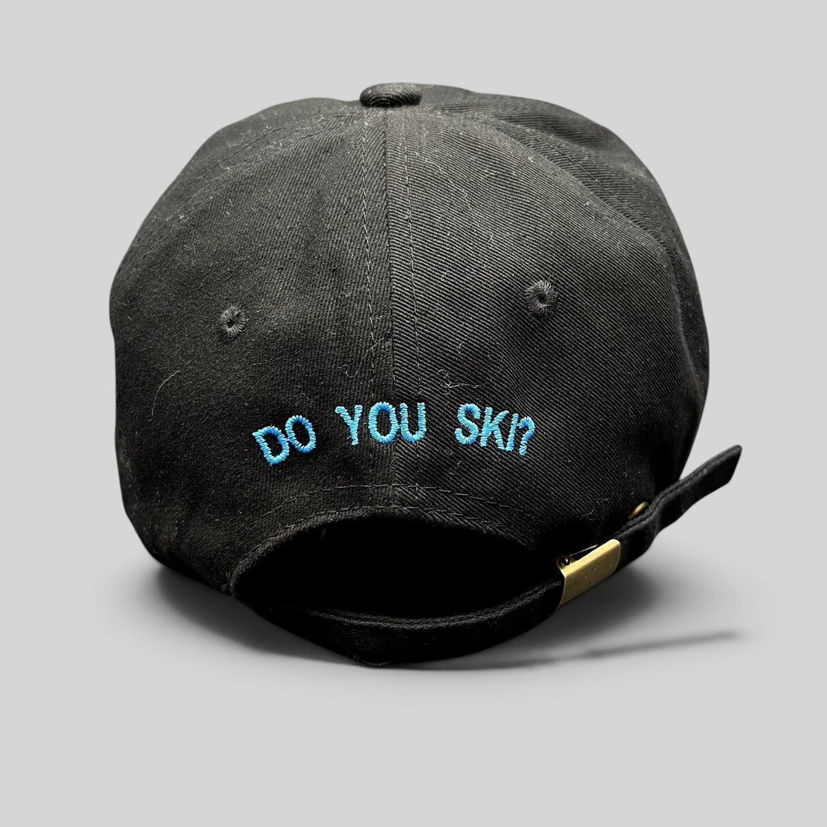 Raree Finds black cotton strapback hat with blue embroidered DO YOU SKI text on the back and adjustable metal buckle