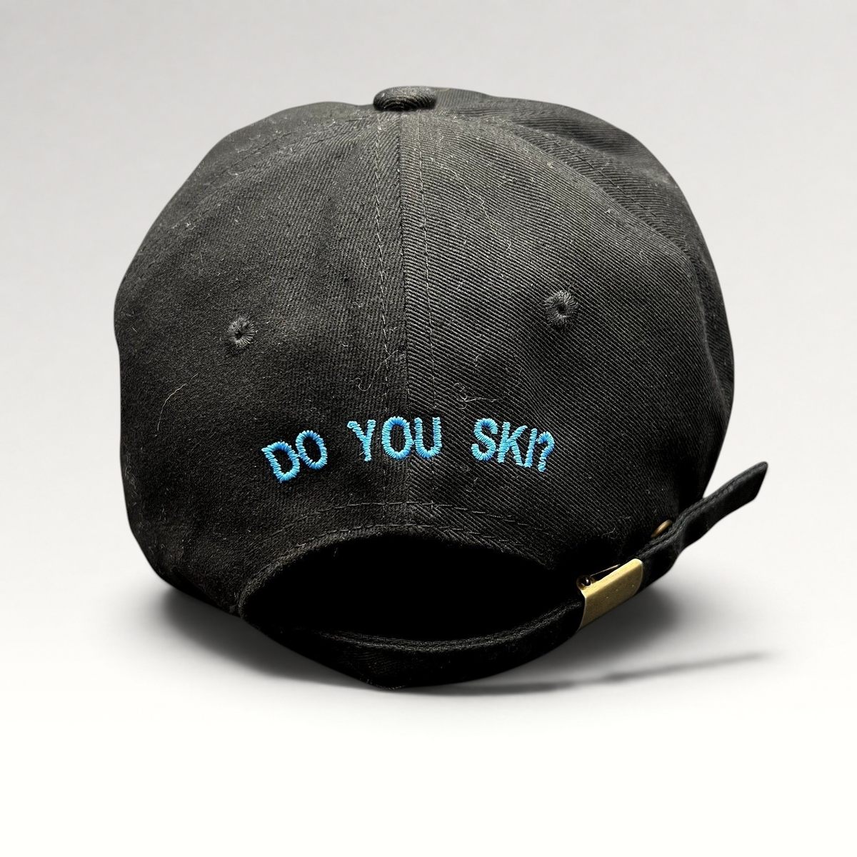 Raree Finds black cotton strapback hat with blue embroidered DO YOU SKI text on the back and adjustable metal buckle