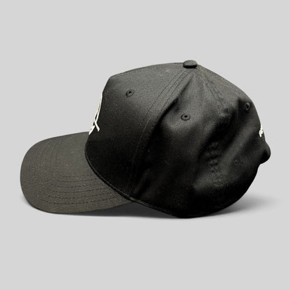 Raree Finds black snapback hat with embroidered globe logo and structured six-panel design, side profile view.