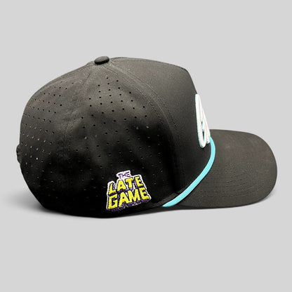 Raree Finds black snapback hat with perforated sides, teal rope, and The Late Game side embroidery.