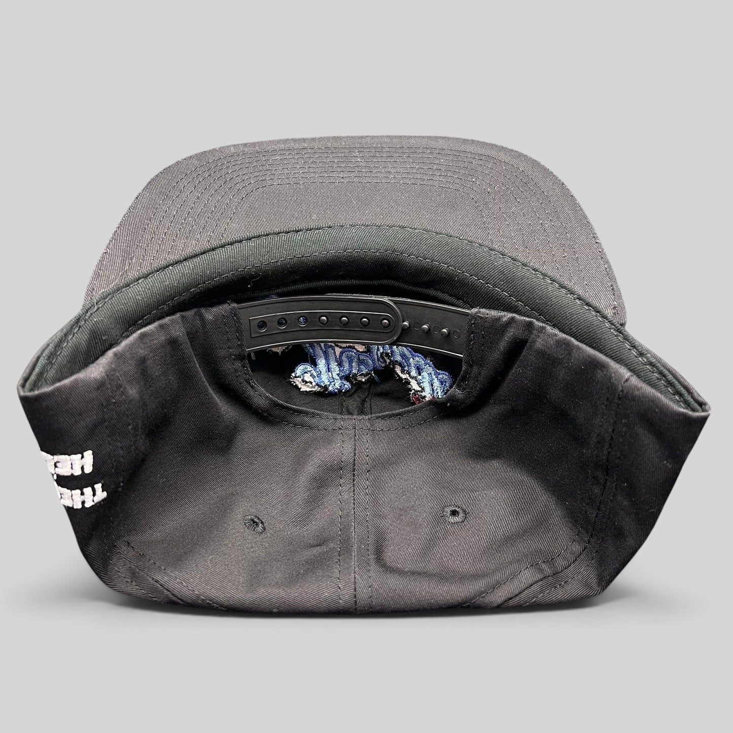 Raree Finds The Hundreds x Hello Kitty black cotton snapback hat showing the adjustable strap and interior details
