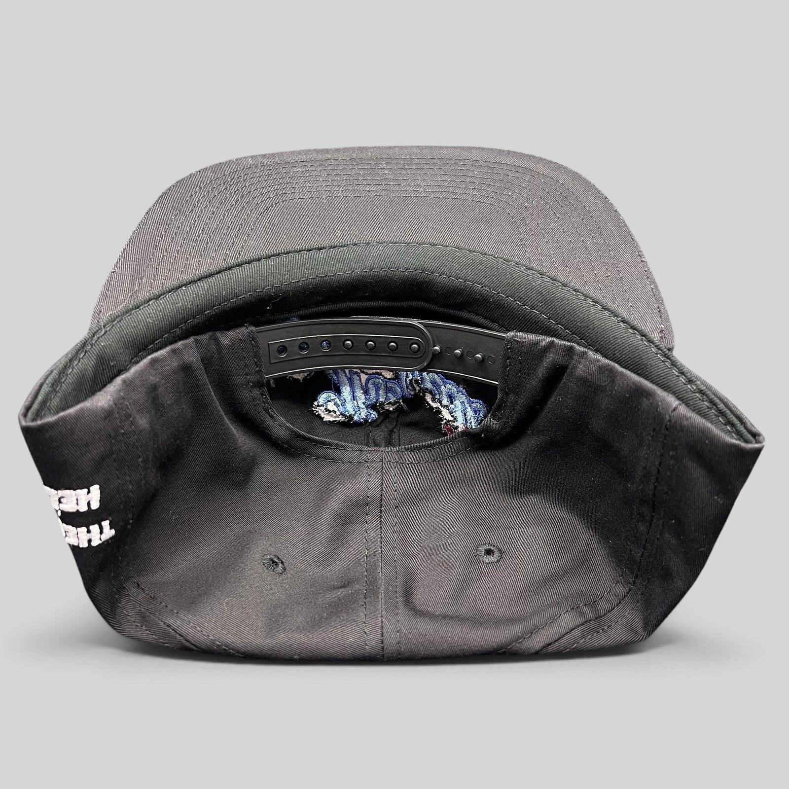 Raree Finds The Hundreds x Hello Kitty black cotton snapback hat showing the adjustable strap and interior details