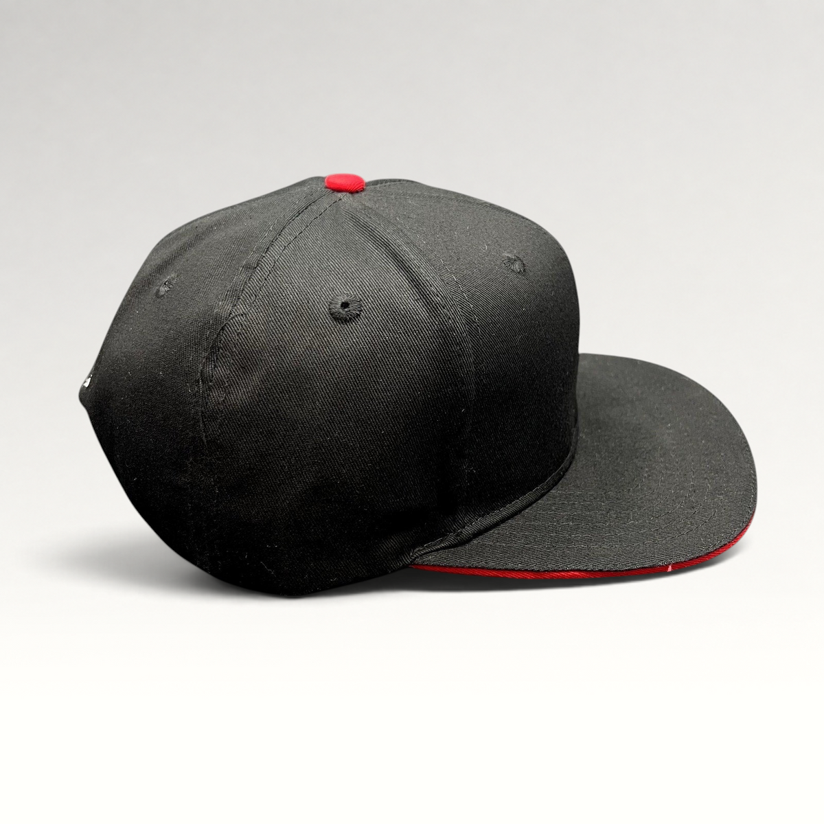 Raree Finds black snapback hat with red button detail and flat brim, featuring motorsports racing style