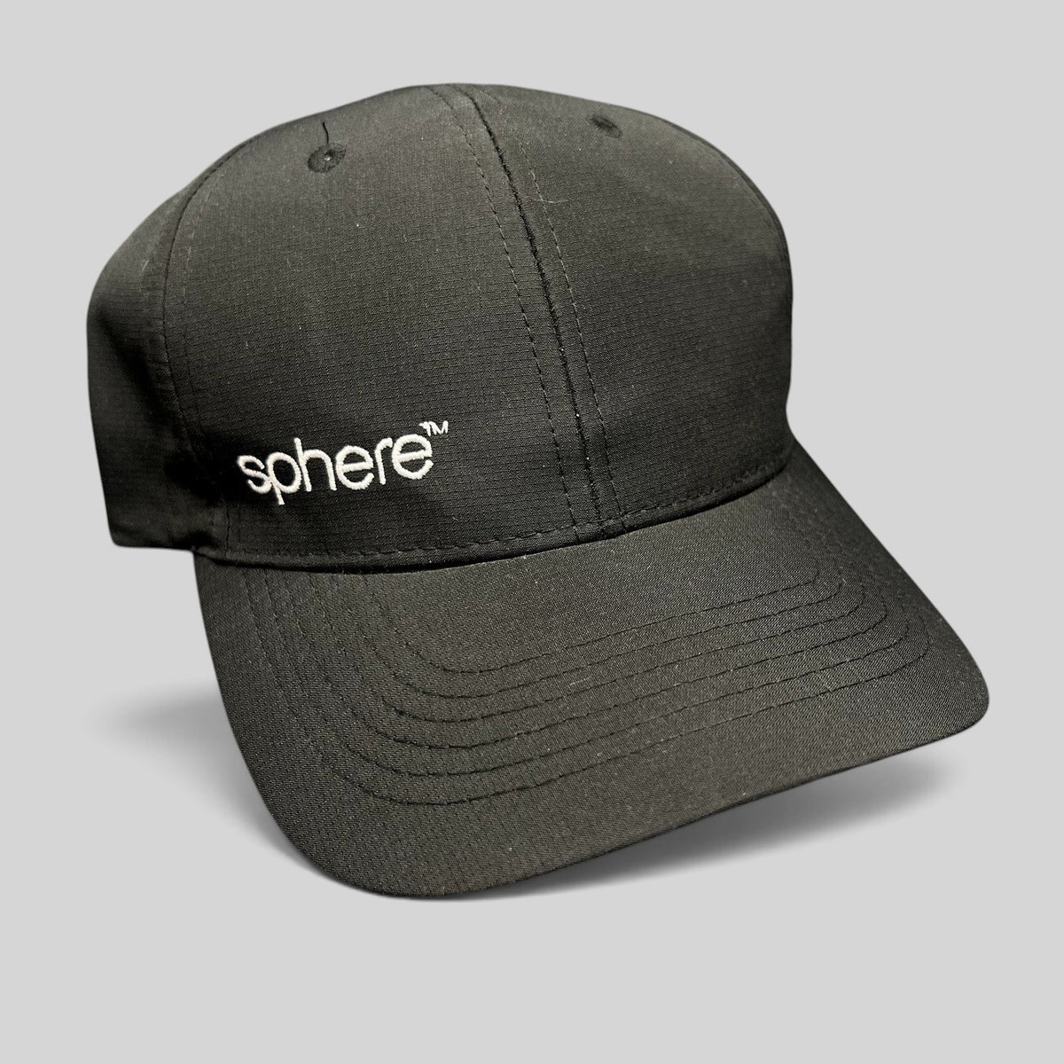 Raree Finds black strapback hat with white sphere logo embroidery and curved brim in a minimalist polyester design.