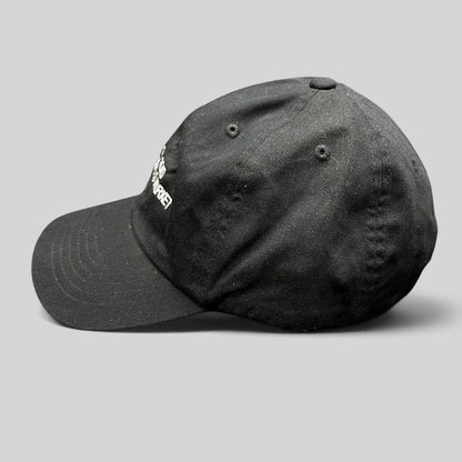Raree Finds black cotton strapback dad cap with white Silk Road Anonymous Market embroidery, side profile view.