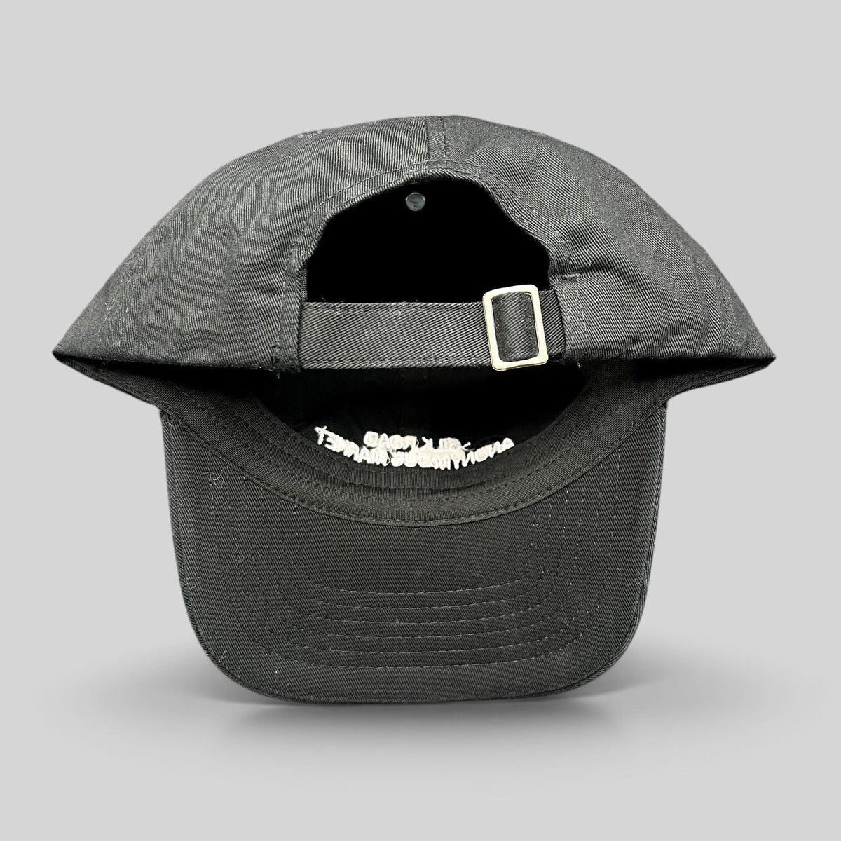 Raree Finds black Yupoong strapback dad cap with adjustable metal buckle closure and interior embroidery detail