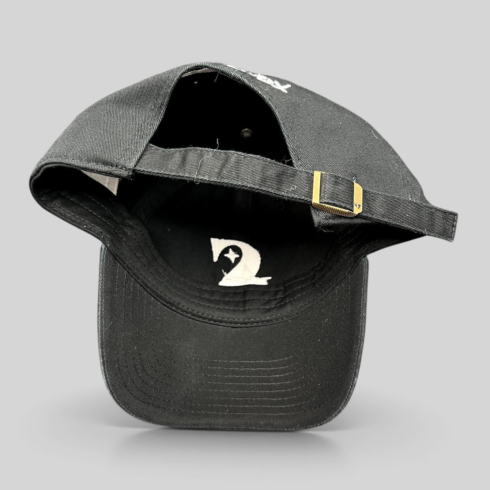 Raree Finds 47 Brand black cotton strapback hat with adjustable brass buckle and white interior logo detail