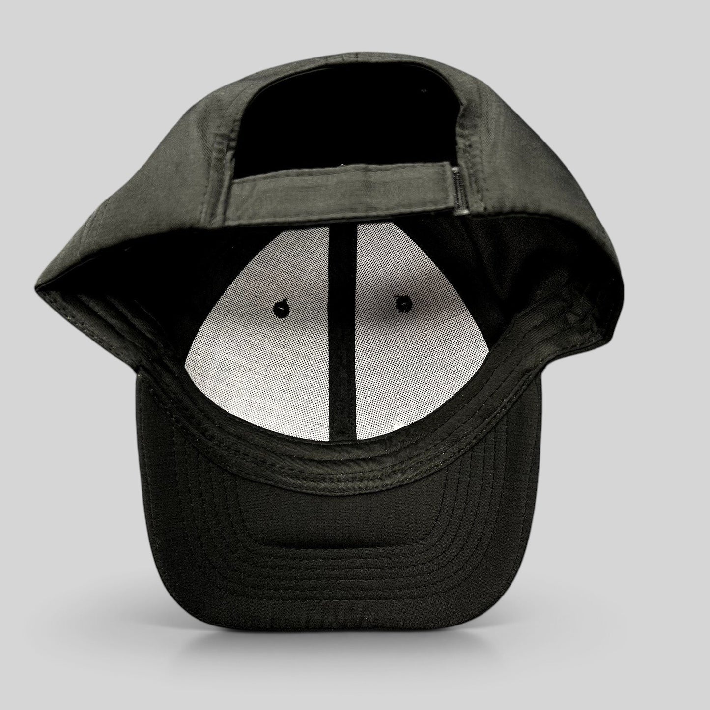 Raree Finds black strapback hat with adjustable fabric strap and unstructured polyester construction, back view.