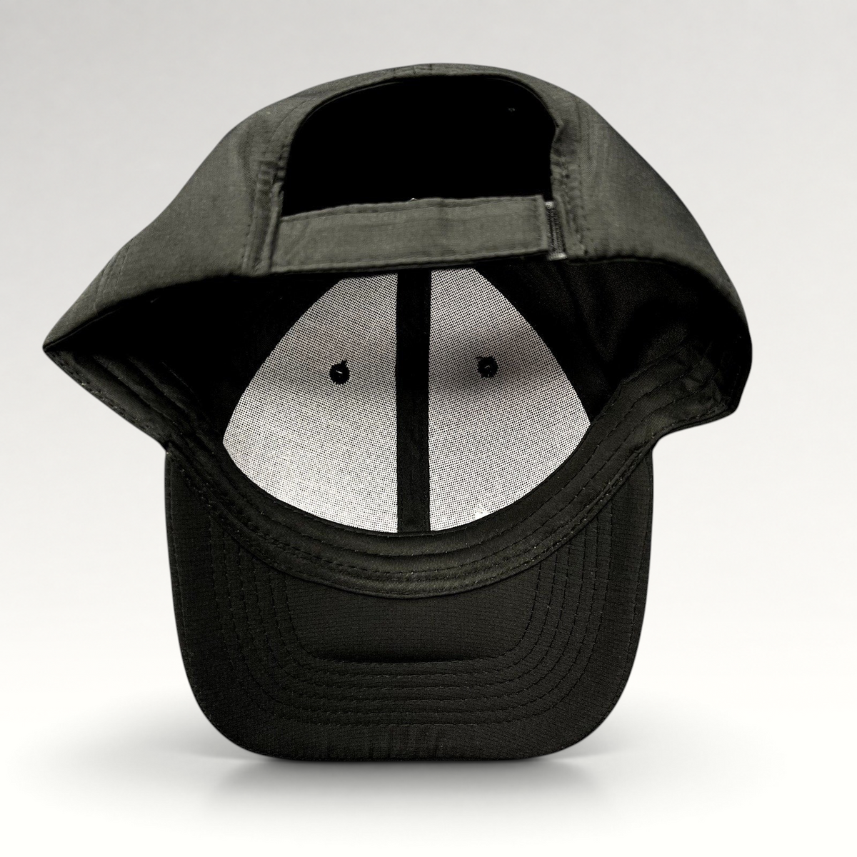 Raree Finds black strapback hat with adjustable fabric strap and unstructured polyester construction, back view.