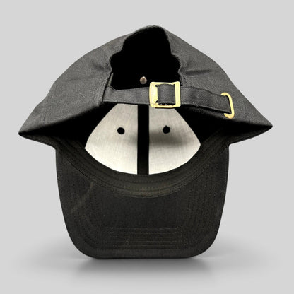 Raree Finds black cotton strapback hat with adjustable brass buckle closure, showing the interior and back view.