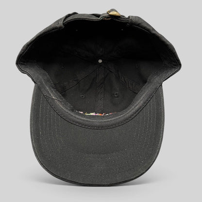 Raree Finds black cotton strapback hat interior view showing the adjustable metal slider and curved brim construction.