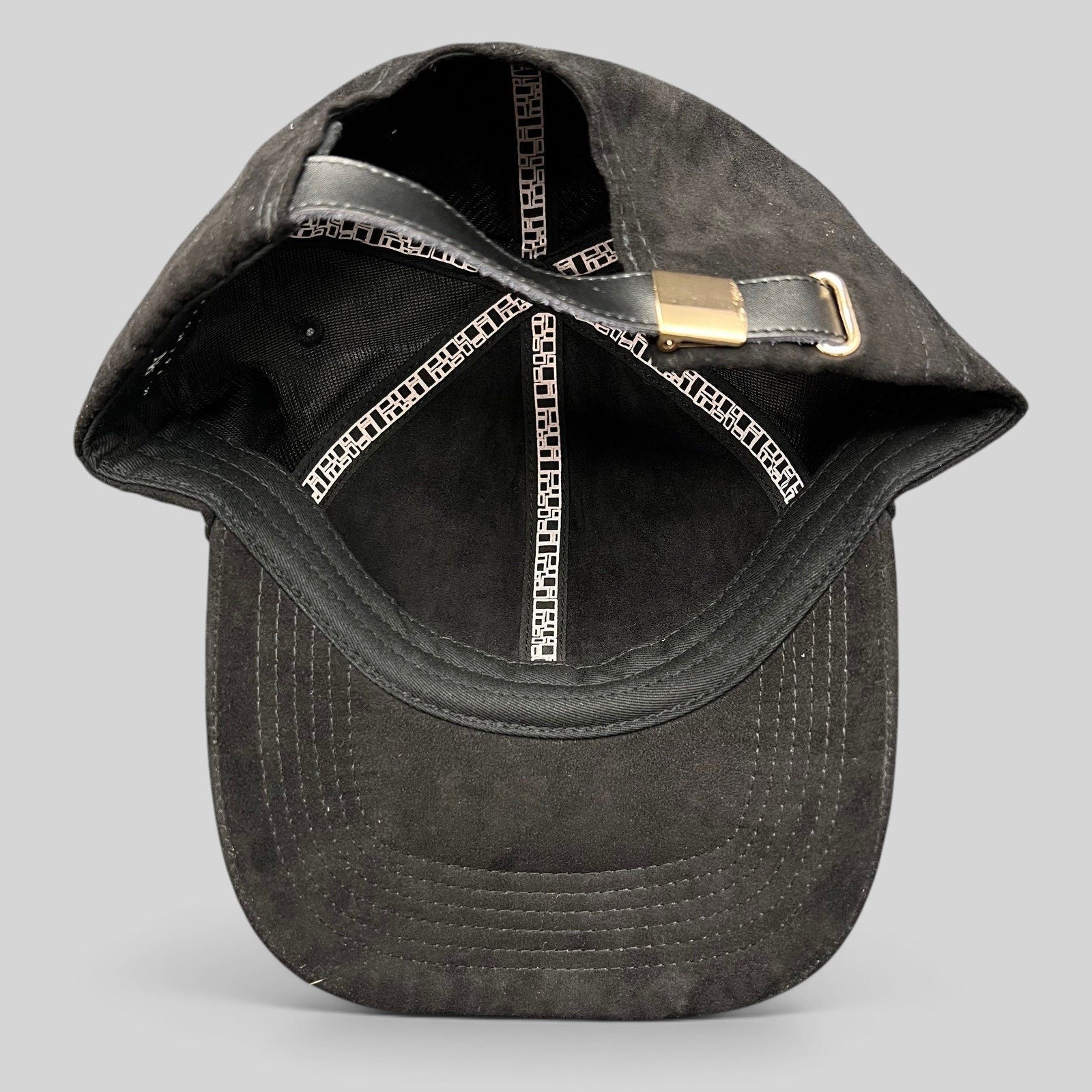 Raree Finds Metal Noir black unstructured strapback hat with leather strap and metal buckle, interior view