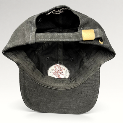 Raree Finds black cotton strapback hat with adjustable brass buckle, showing interior construction and branding.