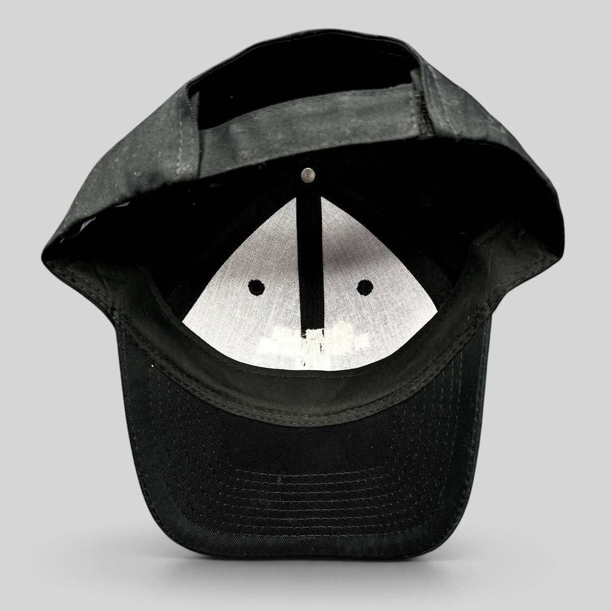 Raree Finds black Port & Company strapback hat showing the interior construction and adjustable back closure