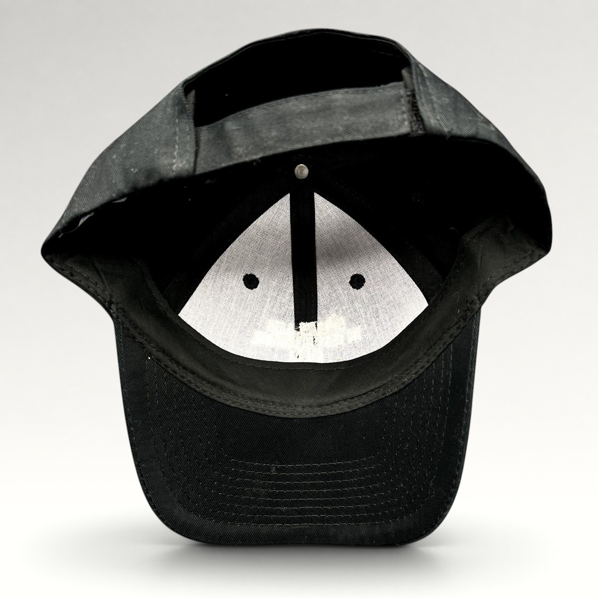 Raree Finds black Port & Company strapback hat showing the interior construction and adjustable back closure
