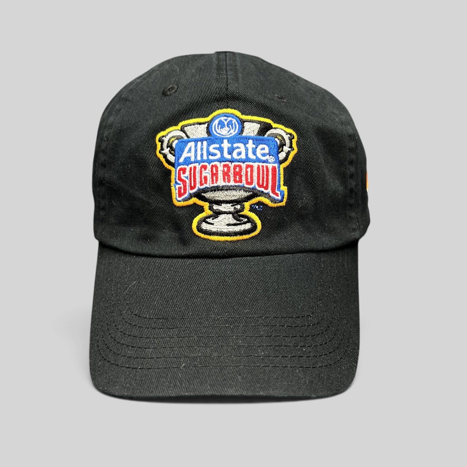 Raree Finds black Bayou Apparel strapback hat featuring an embroidered Allstate Sugar Bowl trophy logo on the front.