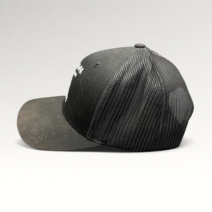 Raree Finds black Yupoong trucker snapback hat with The Talpa Est. 1962 embroidered cactus mascot logo, side profile.