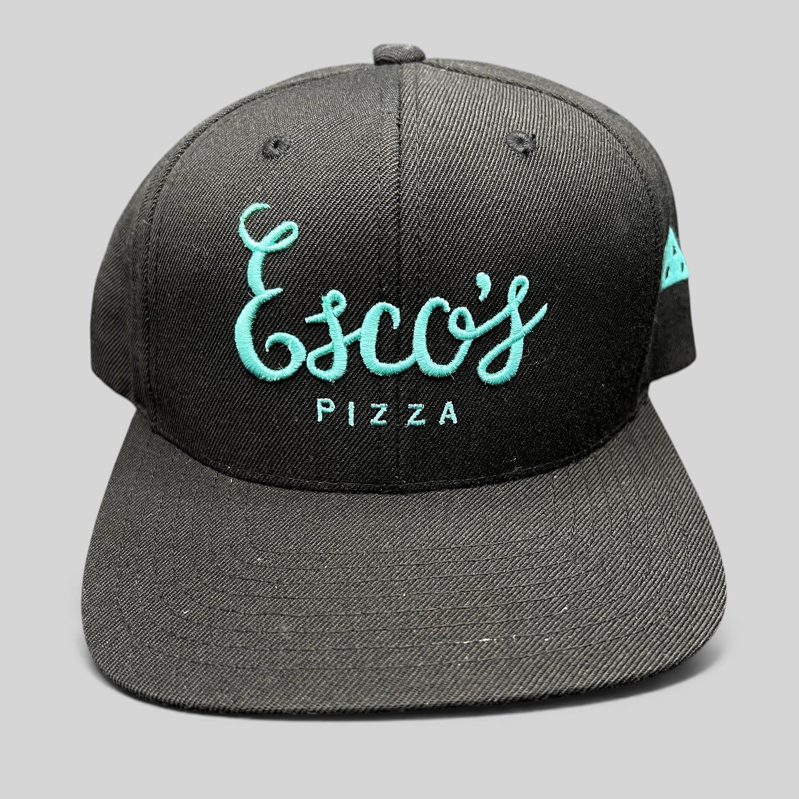 Raree Finds black snapback hat with teal Esco's Pizza script embroidery on the front and a flat brim