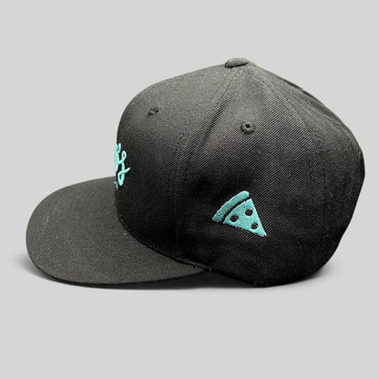 Raree Finds black snapback hat with teal Esco’s Pizza script embroidery and a pizza slice icon on the side panel.