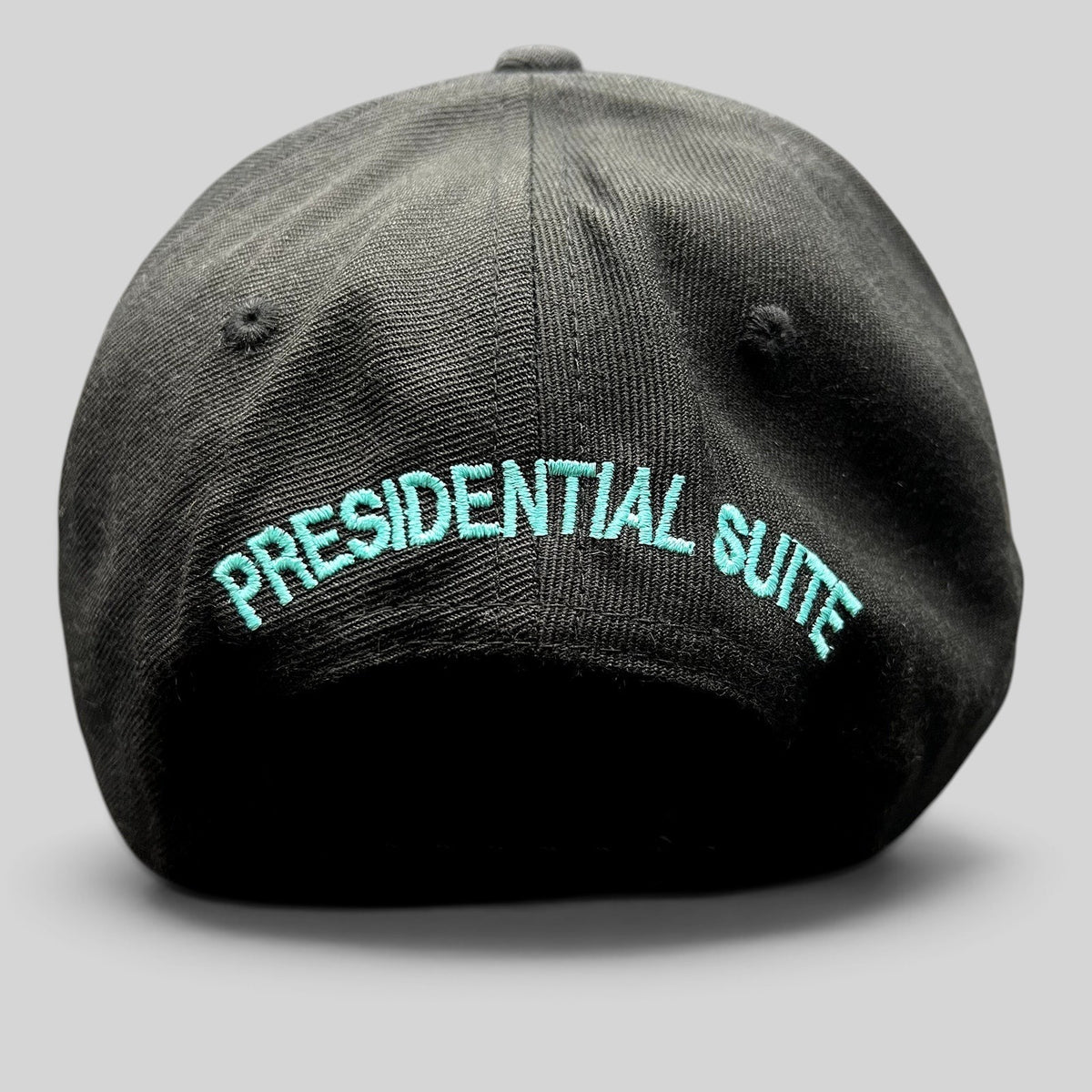Raree Finds black snapback hat featuring teal Presidential Suite embroidery on the back with a structured crown