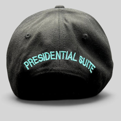 Raree Finds black snapback hat featuring teal Presidential Suite embroidery on the back with a structured crown