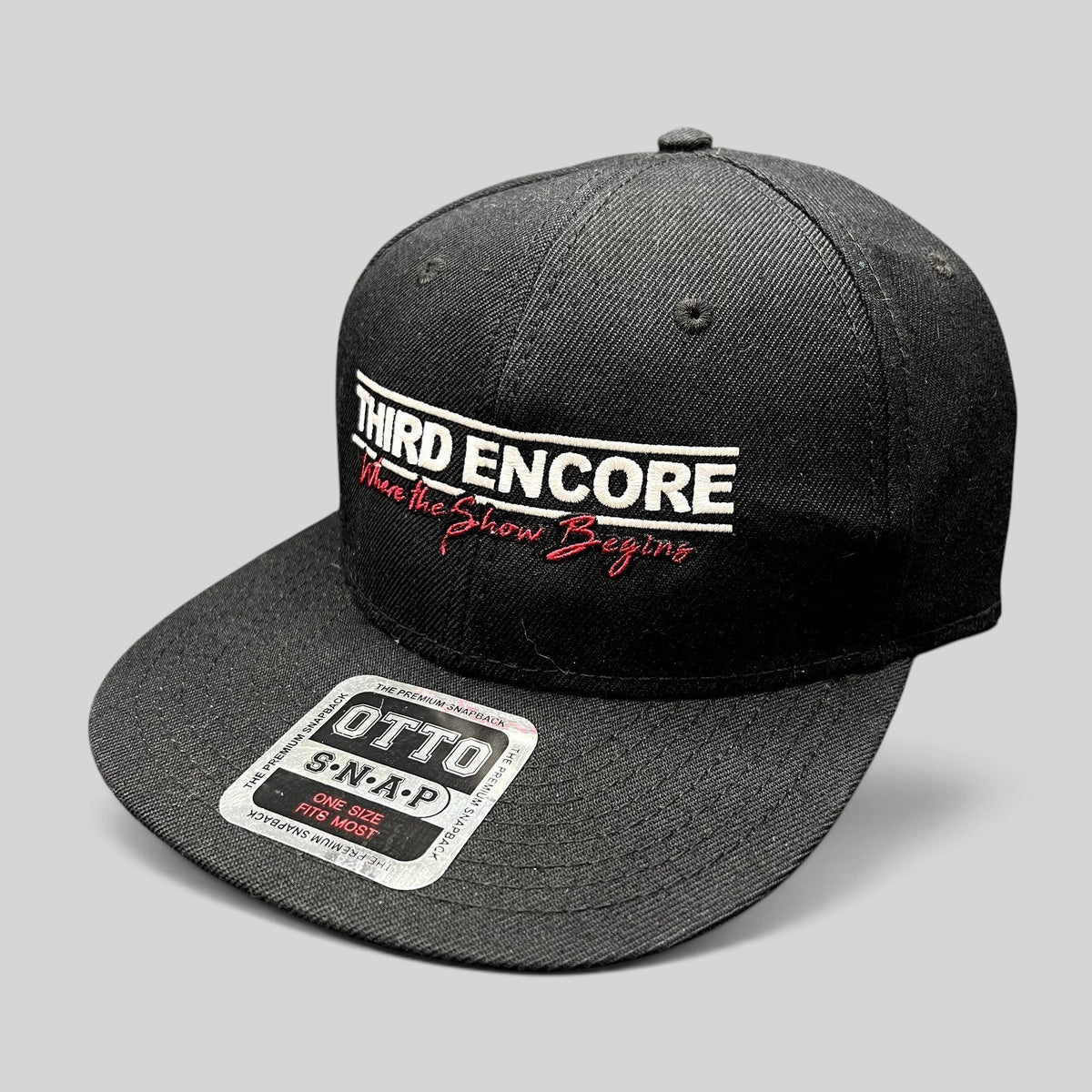 Raree Finds black OTTO snapback hat with white Third Encore embroidery and red script tagline on a flat brim cap.