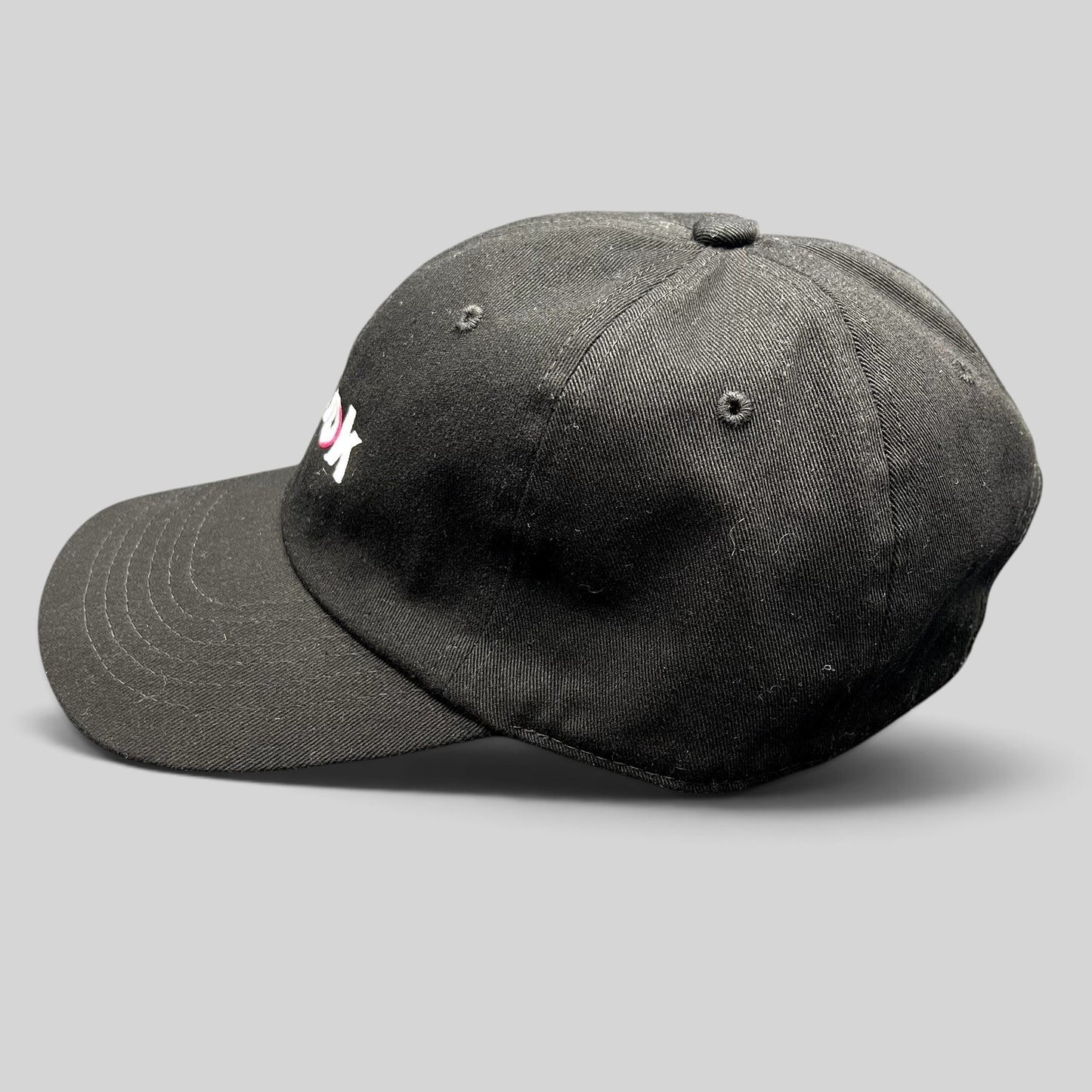 Raree Finds black cotton dad cap with embroidered TikTok logo, featuring a curved brim and unstructured crown.