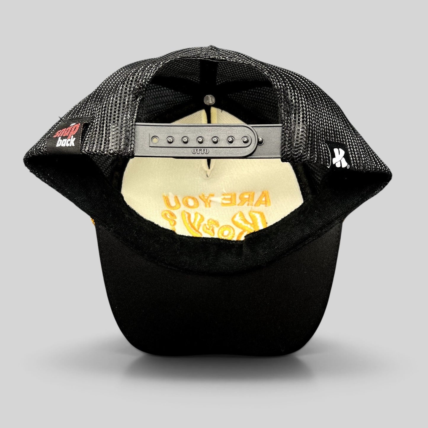 Raree Finds Are You Kozy? black trucker hat showing the interior mesh lining and adjustable Otto snapback closure