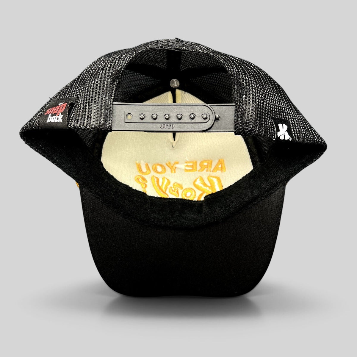 Raree Finds Are You Kozy? black trucker hat showing the interior mesh lining and adjustable Otto snapback closure