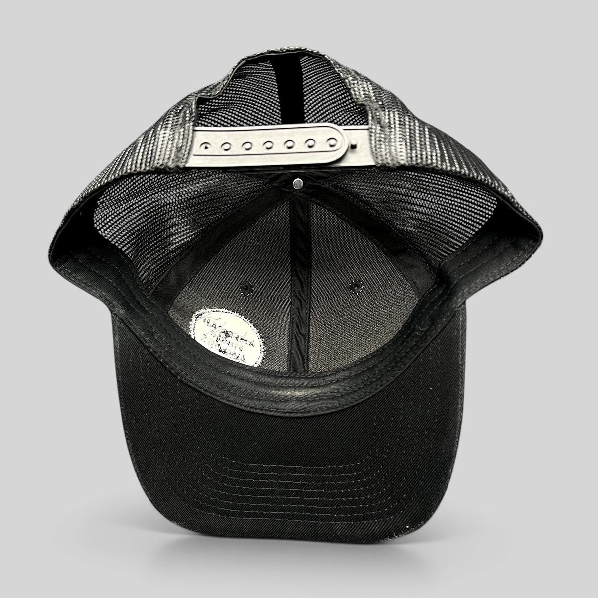Raree Finds American Music Awards black trucker hat showing the interior mesh lining and adjustable snapback closure.