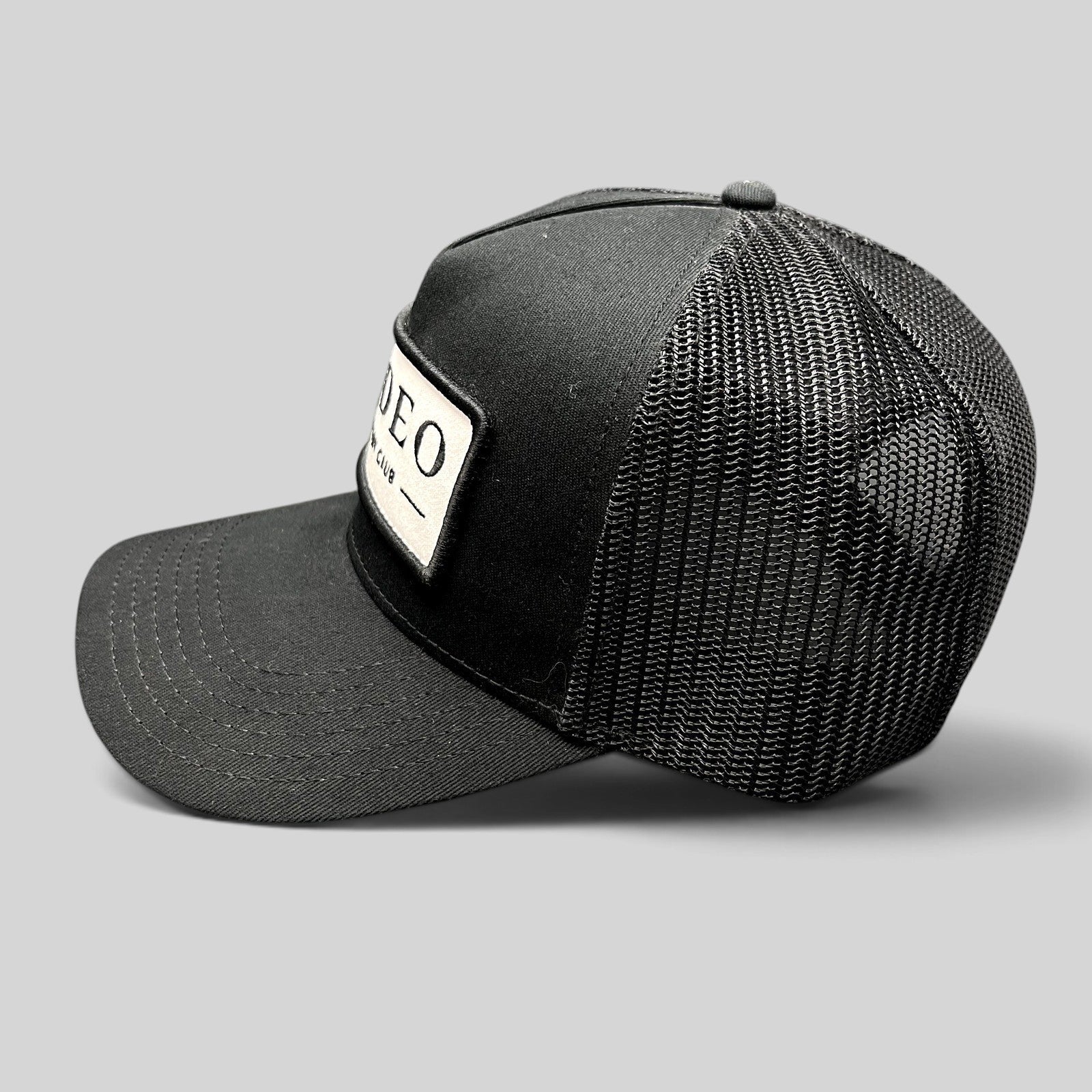 Raree Finds black Rodeo Country Club trucker hat with a structured front patch and breathable mesh back panel