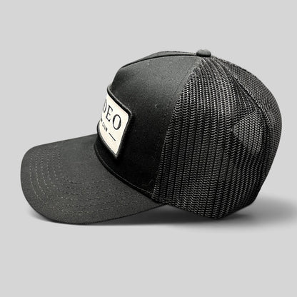 Raree Finds black Rodeo Country Club trucker hat with a structured front patch and breathable mesh back panel