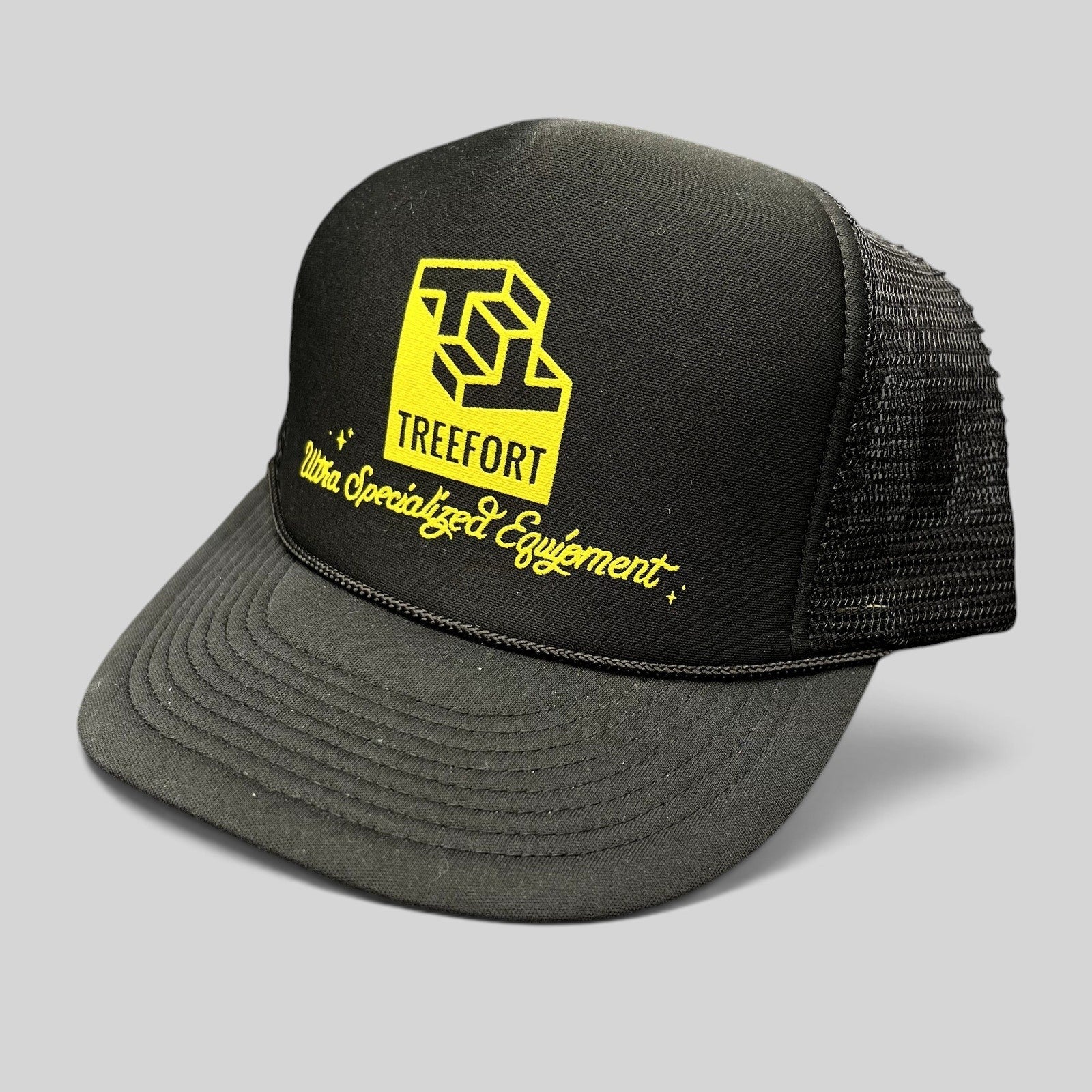 Raree Finds black trucker hat with yellow Treefort Ultra Specialized Equipment graphic and braided brim detail.