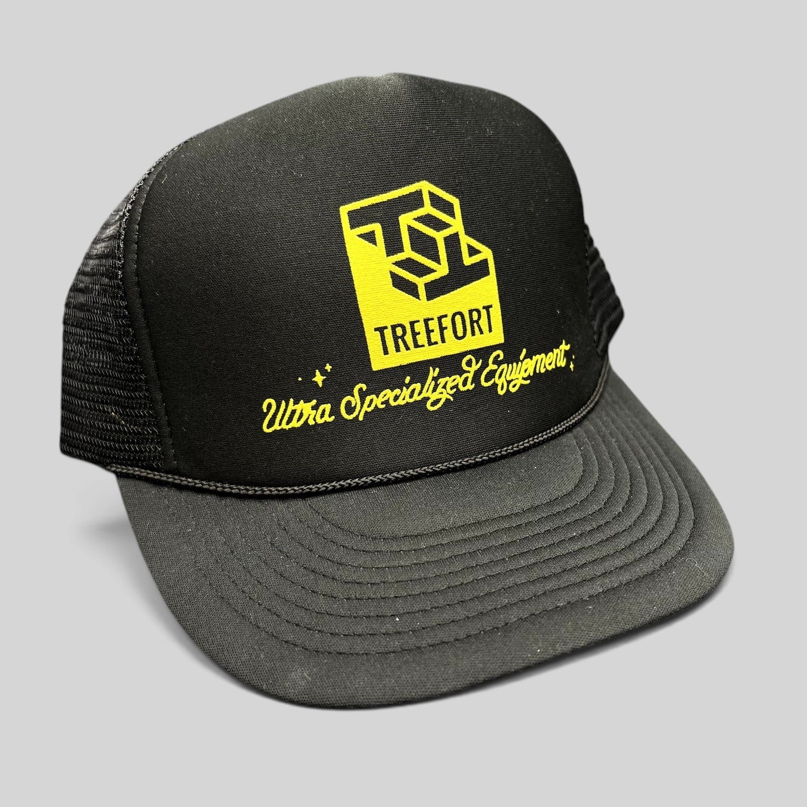 Raree Finds black trucker hat with yellow Treefort Ultra Specialized Equipment graphic and braided brim rope detail.