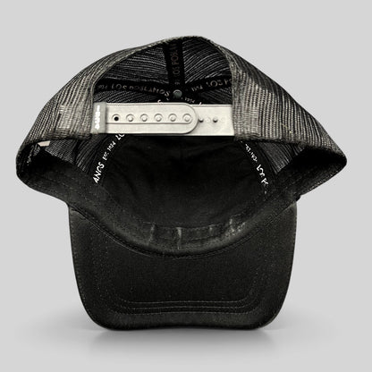 Raree Finds black trucker hat with mesh back, curved brim, and adjustable snapback closure showing interior branding.