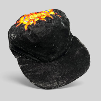 Raree Finds vintage black velvet cap featuring a colorful embroidered southwestern sun face motif on the crown.